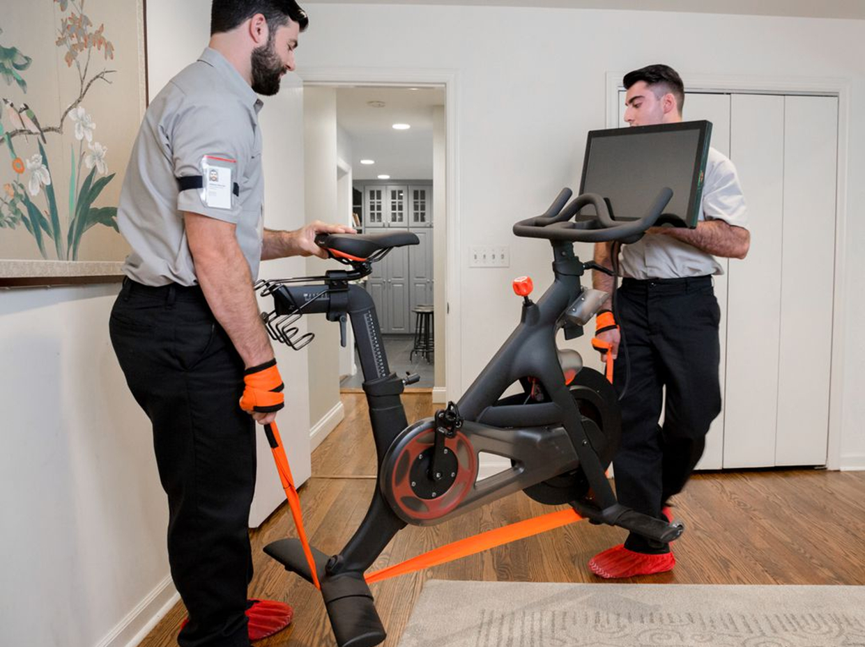 Two RXO independent owner-operators delivering exercise equipment to a customer home