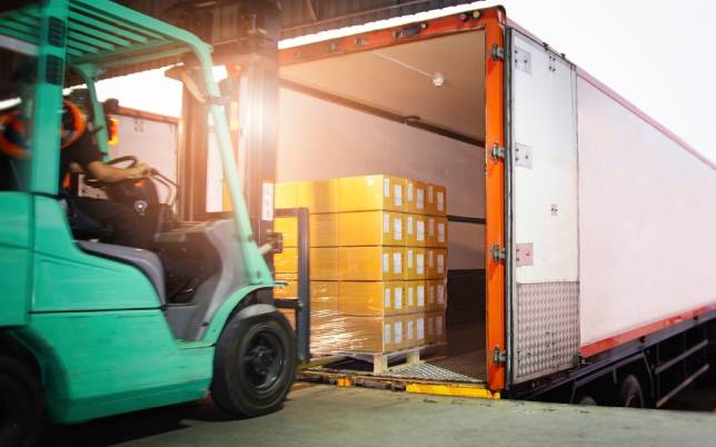 Forklift loading pallets onto trailer